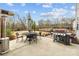 Spacious backyard patio with grilling station, outdoor table and chairs, and a charming umbrella at 5030 Lily Pond Cir, Waxhaw, NC 28173