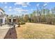 Expansive backyard showcasing lush landscaping, a patio with a grill, and an inviting outdoor dining area at 5030 Lily Pond Cir, Waxhaw, NC 28173