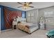 A stylish bedroom with a unique accent wall, neutral-toned bedding, and a full-length mirror at 5030 Lily Pond Cir, Waxhaw, NC 28173