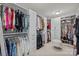 Spacious walk-in closet featuring ample shelving, drawers, and a comfortable seating area at 5030 Lily Pond Cir, Waxhaw, NC 28173