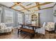 Elegant dining room with a wooden table, bar, and decorative ceiling beams at 5030 Lily Pond Cir, Waxhaw, NC 28173