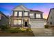 Charming two-story home featuring a welcoming front porch and attached two-car garage at 5030 Lily Pond Cir, Waxhaw, NC 28173