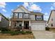 Charming two-story home featuring a welcoming front porch and attached two-car garage at 5030 Lily Pond Cir, Waxhaw, NC 28173