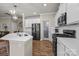 Bright kitchen with stainless steel appliances, white cabinetry, and an island with counter seating at 5030 Lily Pond Cir, Waxhaw, NC 28173
