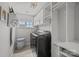 Well-lit laundry room with modern washer and dryer, ample storage, and convenient accessories at 5030 Lily Pond Cir, Waxhaw, NC 28173