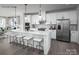 Modern white kitchen featuring stainless steel appliances, large center island and sleek countertops at 5045 Grain Orchard Rd # 3027D, Indian Trail, NC 28079