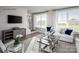 Bright living room with hardwood floors, large windows, stylish furniture, and modern decor at 5045 Grain Orchard Rd # 3027D, Indian Trail, NC 28079