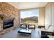 Cozy outdoor patio with brick fireplace, comfortable seating, and serene wooded views at 5045 Grain Orchard Rd # 3027D, Indian Trail, NC 28079