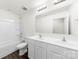 A bright bathroom features a double sink vanity, a mirror, and a shower-tub combo at 5108 Puclerton Dr, Charlotte, NC 28215