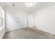 A vacant bedroom has a window view, neutral carpet, and a closet for storage at 5108 Puclerton Dr, Charlotte, NC 28215