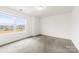 A vacant bedroom has a window view and neutral carpet, creating a cozy space at 5108 Puclerton Dr, Charlotte, NC 28215