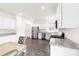 Modern kitchen with stainless steel appliances, granite countertops, white cabinets, and hardwood floors at 5108 Puclerton Dr, Charlotte, NC 28215