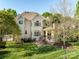 Backyard with manicured lawn, patio, mature trees, and outdoor seating area at 5811 Old Well House Rd, Charlotte, NC 28226