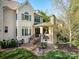 Home's backyard features a brick patio, outdoor seating, and a hammock at 5811 Old Well House Rd, Charlotte, NC 28226