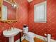 Elegant powder room with patterned wallpaper, a pedestal sink, and a window with plantation shutters at 5811 Old Well House Rd, Charlotte, NC 28226