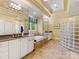 Bright bathroom with a jacuzzi tub, glass block shower, double sinks, and large mirrors at 5811 Old Well House Rd, Charlotte, NC 28226