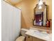 Well-lit bathroom features a decorative mirror and neutral wallpaper at 5811 Old Well House Rd, Charlotte, NC 28226