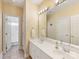 Bright bathroom featuring a double vanity and tile flooring at 5811 Old Well House Rd, Charlotte, NC 28226