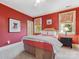 Comfortable bedroom with red walls, white trim, carpet and two windows at 5811 Old Well House Rd, Charlotte, NC 28226