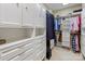 Walk-in closet featuring custom white cabinets, drawers, shelves, and ample space for clothes and accessories at 5811 Old Well House Rd, Charlotte, NC 28226