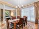 Elegant dining room with a chandelier, large window, and stylish furniture creating a refined atmosphere at 5811 Old Well House Rd, Charlotte, NC 28226