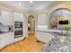 Spacious kitchen with granite countertops, stainless appliances, hardwood floors and an arched doorway at 5811 Old Well House Rd, Charlotte, NC 28226