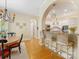 Charming kitchen with a view of the dining area, bar stool seating, and white cabinets at 5811 Old Well House Rd, Charlotte, NC 28226