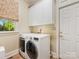 Convenient laundry room with a front load washer and dryer and storage cabinets at 5811 Old Well House Rd, Charlotte, NC 28226