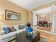 Cozy living room with a white sofa, decorative pillows, and an open view into dining area at 5811 Old Well House Rd, Charlotte, NC 28226