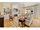 Inviting living room featuring hardwood floors, built-in bookcases, a fireplace and ample natural light at 5811 Old Well House Rd, Charlotte, NC 28226