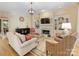 Bright living room with built-in shelving, fireplace, hardwood floors and stylish decor at 5811 Old Well House Rd, Charlotte, NC 28226