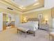 Luxurious main bedroom with tray ceilings, a sitting area, and access to an upstairs hallway at 5811 Old Well House Rd, Charlotte, NC 28226