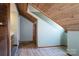 Open attic with wooden ceiling, a wall painted green, and closet doors and a bathroom in view at 6199 Timberlane Ter, Hickory, NC 28601
