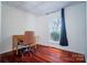 Bedroom featuring a desk, chair, and hardwood floors, with light from the window creating an inviting space at 6199 Timberlane Ter, Hickory, NC 28601