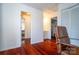 Bedroom with wood floors, adjacent to a bathroom, and a doorway to another bedroom in the background at 6199 Timberlane Ter, Hickory, NC 28601