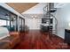 Open living area with hardwood floors, spiral staircase, sliding glass doors, and seating area at 6199 Timberlane Ter, Hickory, NC 28601