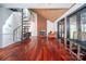 Bright living room featuring hardwood floors, a fireplace, spiral staircase, and sliding glass doors at 6199 Timberlane Ter, Hickory, NC 28601