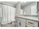 Bathroom with white vanity and granite countertop, featuring modern fixtures and a shower with curtain at 6276 Artigas Dr, Fort Mill, SC 29707