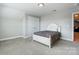 Cozy bedroom with white bed frame, carpet, and gray walls, showcasing a comfortable and inviting space at 6276 Artigas Dr, Fort Mill, SC 29707