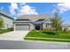 Charming single-Gathering home with stone accents, well-manicured lawn, and attached garage at 6276 Artigas Dr, Fort Mill, SC 29707