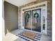 Inviting double front door with stone accents, welcome mat, and wreaths at 6276 Artigas Dr, Fort Mill, SC 29707