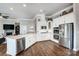 Well-appointed kitchen with stainless steel appliances, white cabinetry, and hardwood flooring at 6276 Artigas Dr, Fort Mill, SC 29707