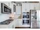 This kitchen features sleek, stainless steel appliances and modern white cabinetry for a clean, sophisticated look at 6276 Artigas Dr, Fort Mill, SC 29707