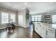 An open-concept living area with a dining space, an oversized island, and beautiful hardwood floors at 6276 Artigas Dr, Fort Mill, SC 29707