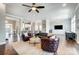 Bright and airy living room with hardwood floors, modern furniture, and easy access to kitchen at 6276 Artigas Dr, Fort Mill, SC 29707