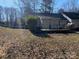 Expansive backyard with a large deck, a lush lawn, mature trees, and ample space for outdoor entertaining and recreation at 6536 Pineburr Rd, Charlotte, NC 28211