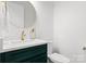 Modern powder room featuring a round mirror, stylish vanity with gold hardware, and a contemporary toilet at 7322 Bay Ridge Dr, Denver, NC 28037