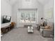 Bright bonus room showcasing vaulted ceiling, large windows with woodsy view, and comfortable seating at 7322 Bay Ridge Dr, Denver, NC 28037
