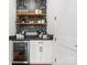 Chic coffee bar area featuring open shelving, a beverage fridge, and stylish decor for coffee enthusiasts at 7322 Bay Ridge Dr, Denver, NC 28037