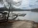 Scenic lake view featuring a wooden dock and calm water on a sunny day at 7322 Bay Ridge Dr, Denver, NC 28037